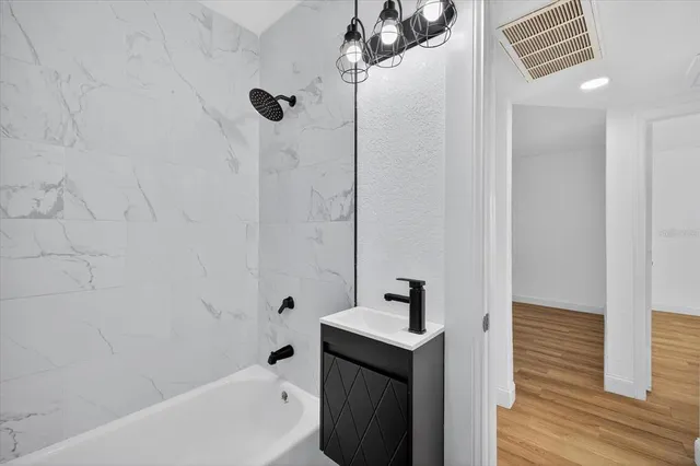 a bathroom with a sink a mirror and a bathtub