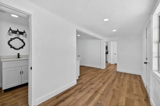 a view of a room with wooden floor