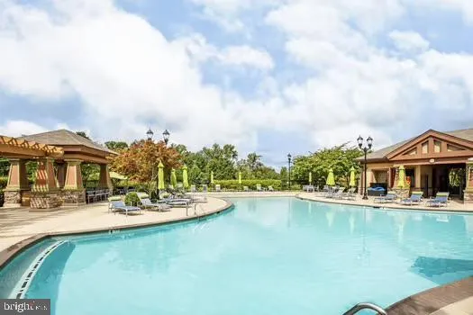a living room with lots of wooden furniture and a table
