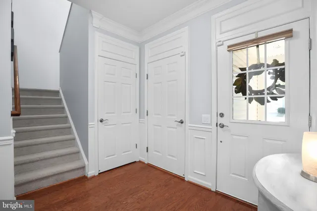 a view of a hallway with wooden floor and entryway