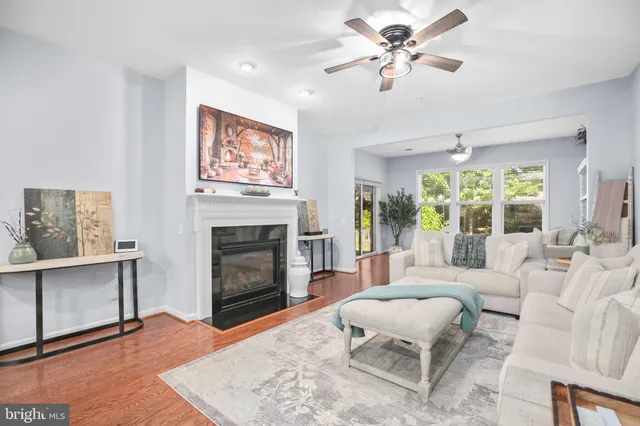 a living room with furniture a fireplace and a large window
