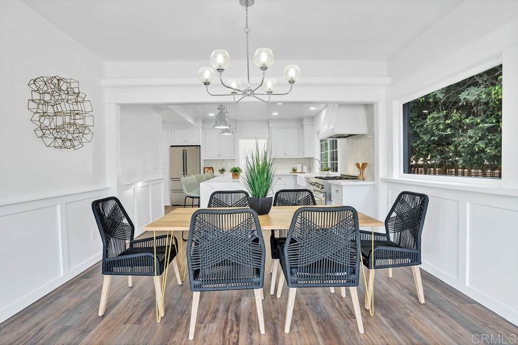 1864 Sunset Boulevard San Diego, CA 92103 - Photo 14 of 57 a view of a dining room with furniture a chandelier and wooden floor