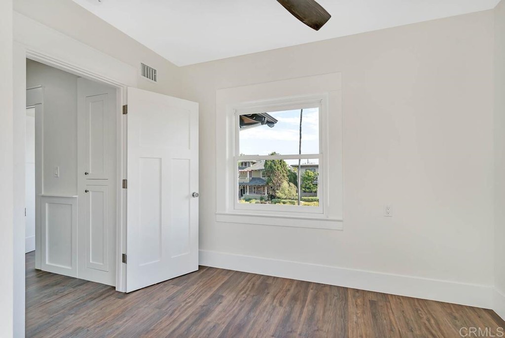 1864 Sunset Boulevard San Diego, CA 92103 - Photo 37 of 57 a view of an empty room with wooden floor and a window