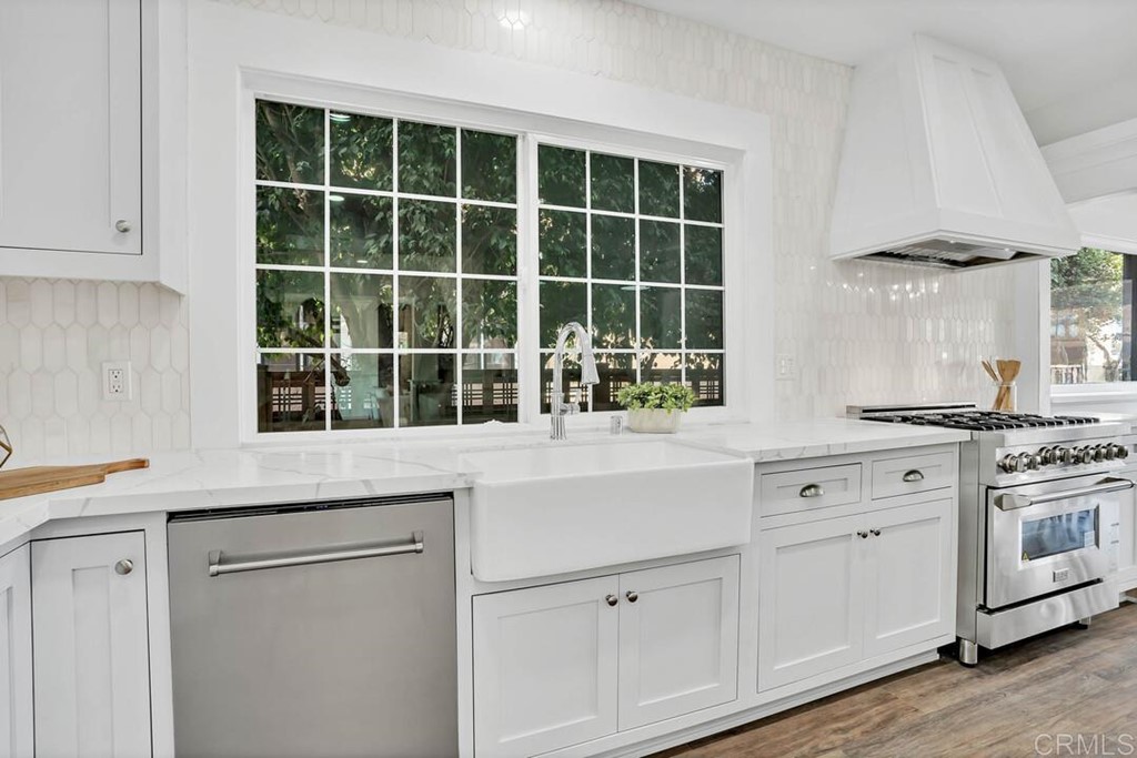 1864 Sunset Boulevard San Diego, CA 92103 - Photo 7 of 57 a kitchen with white cabinets and window