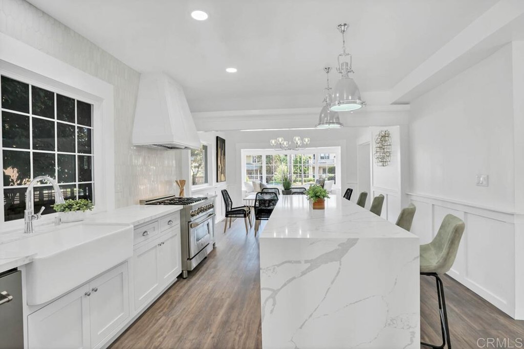 1864 Sunset Boulevard San Diego, CA 92103 - Photo 8 of 57 a large kitchen with sink a center island and stainless steel appliances