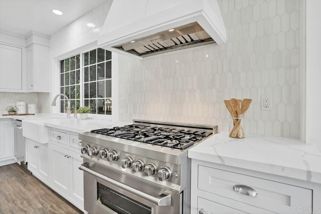 1864 Sunset Boulevard San Diego, CA 92103 - Photo 9 of 57 a kitchen with granite countertop a stove and cabinets