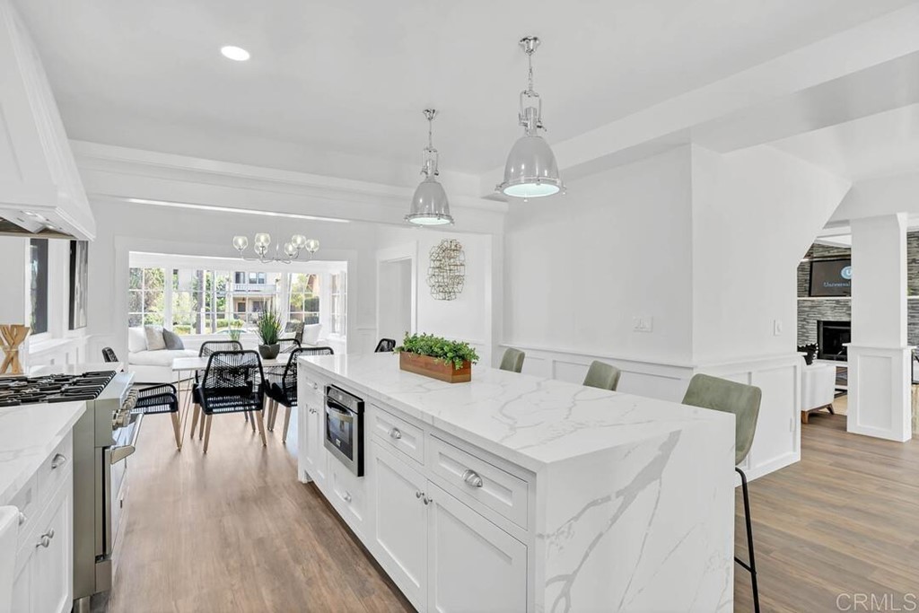 1864 Sunset Boulevard San Diego, CA 92103 - Photo 10 of 57 a view of a dining room and livingroom with furniture wooden floor a chandelier