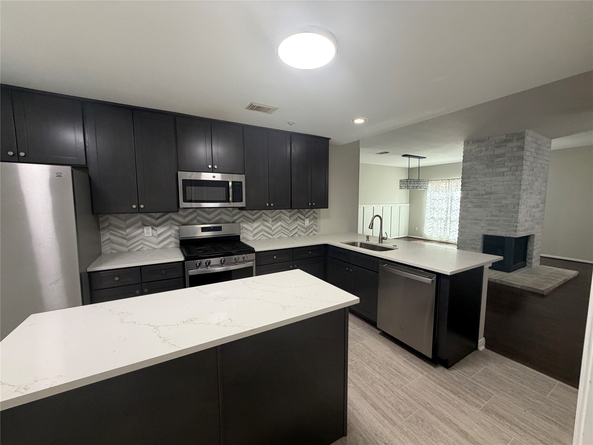 75 East Village Knoll Circle Spring, TX 77381 - Photo 12 of 33 a kitchen with granite countertop a refrigerator stove and sink