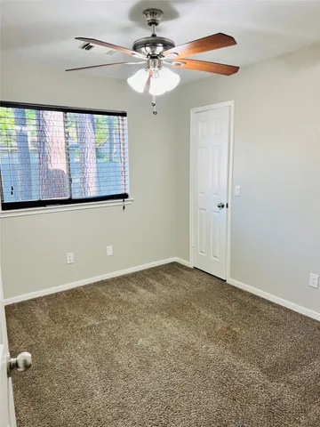 a bathroom with a granite countertop bathtub sink vanity mirror and toilet