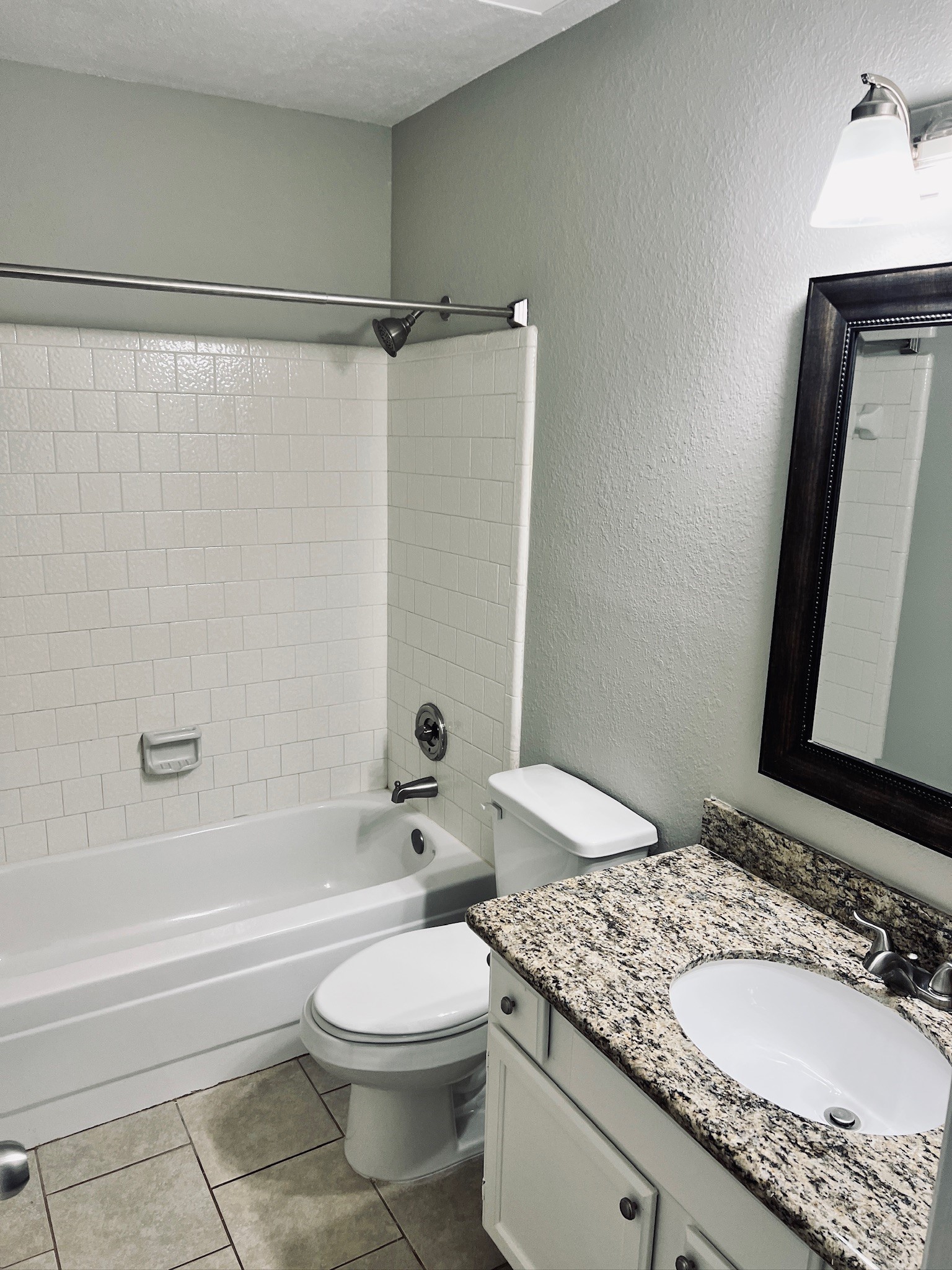 75 East Village Knoll Circle Spring, TX 77381 - Photo 19 of 33 a bathroom with a granite countertop bathtub sink vanity mirror and toilet