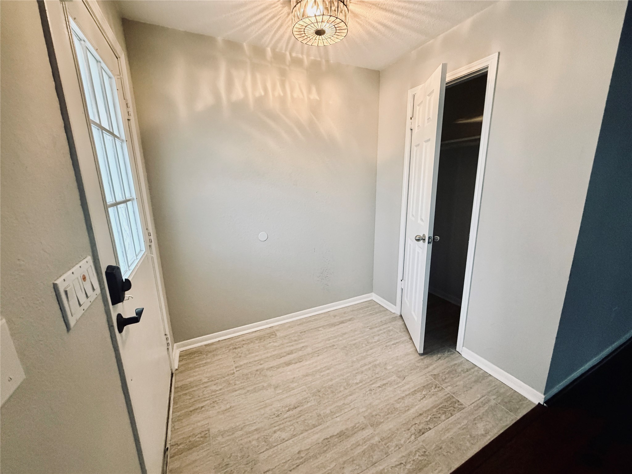 75 East Village Knoll Circle Spring, TX 77381 - Photo 2 of 33 an empty room with wooden floor and entrance