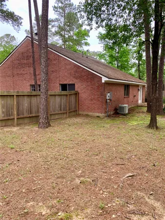 a view of a house with backyard and tree
