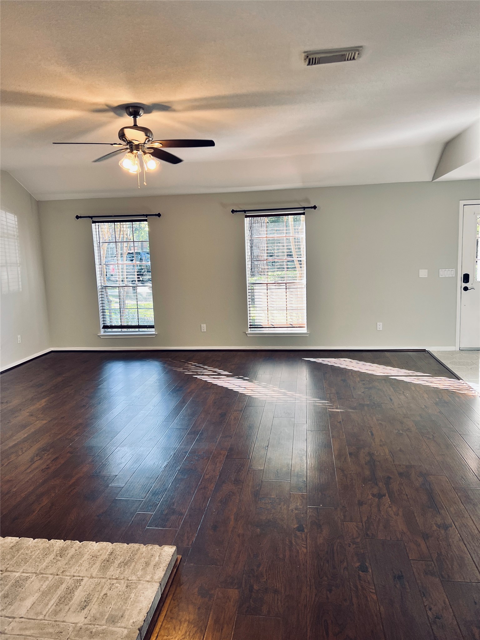75 East Village Knoll Circle Spring, TX 77381 - Photo 5 of 33 a view of an empty room with wooden floor and a window