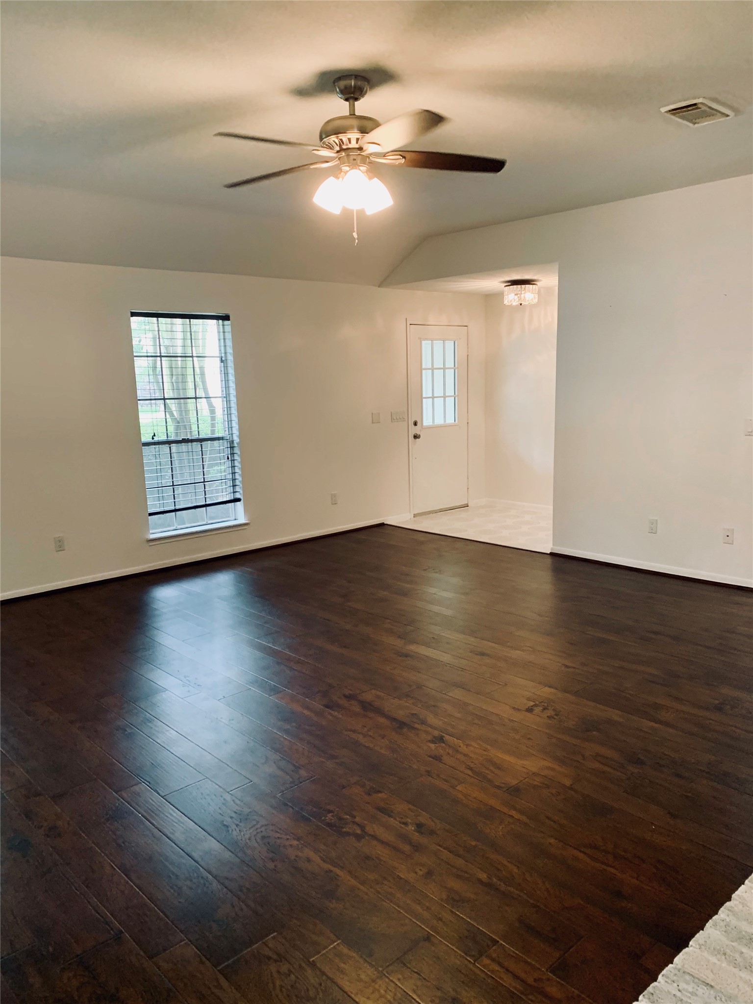 75 East Village Knoll Circle Spring, TX 77381 - Photo 6 of 33 a view of an empty room with wooden floor and a window