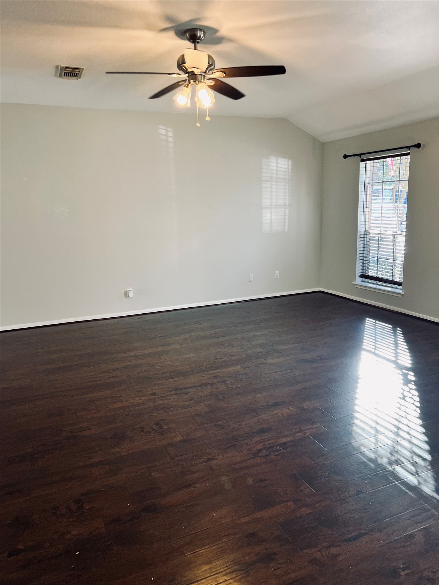 75 East Village Knoll Circle Spring, TX 77381 - Photo 7 of 33 a view of an empty room with wooden floor and a window