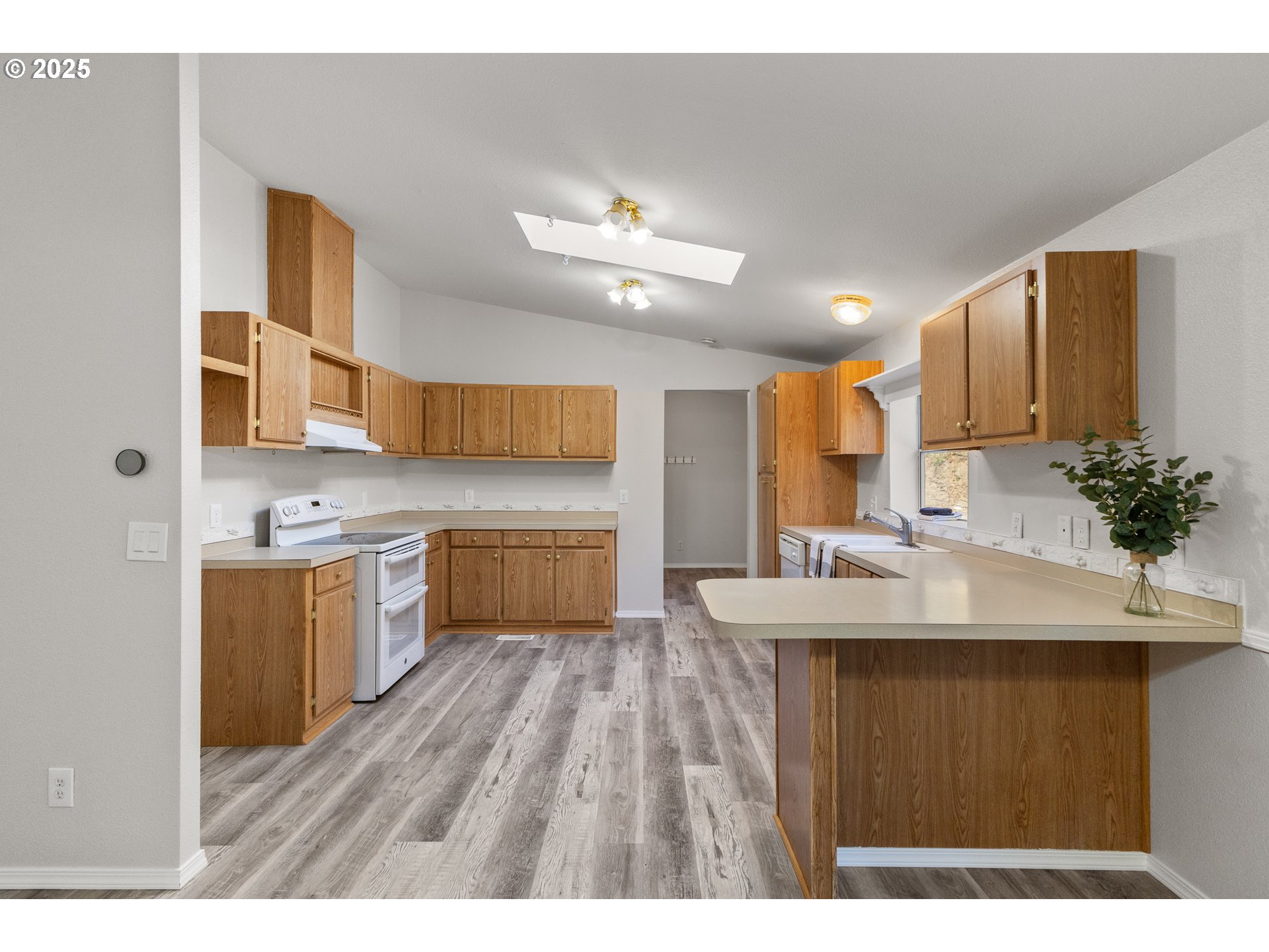 20191 Highway 42 Myrtle Point, OR 97458 - Photo 13 of 41 a kitchen with kitchen island a sink appliances and cabinets