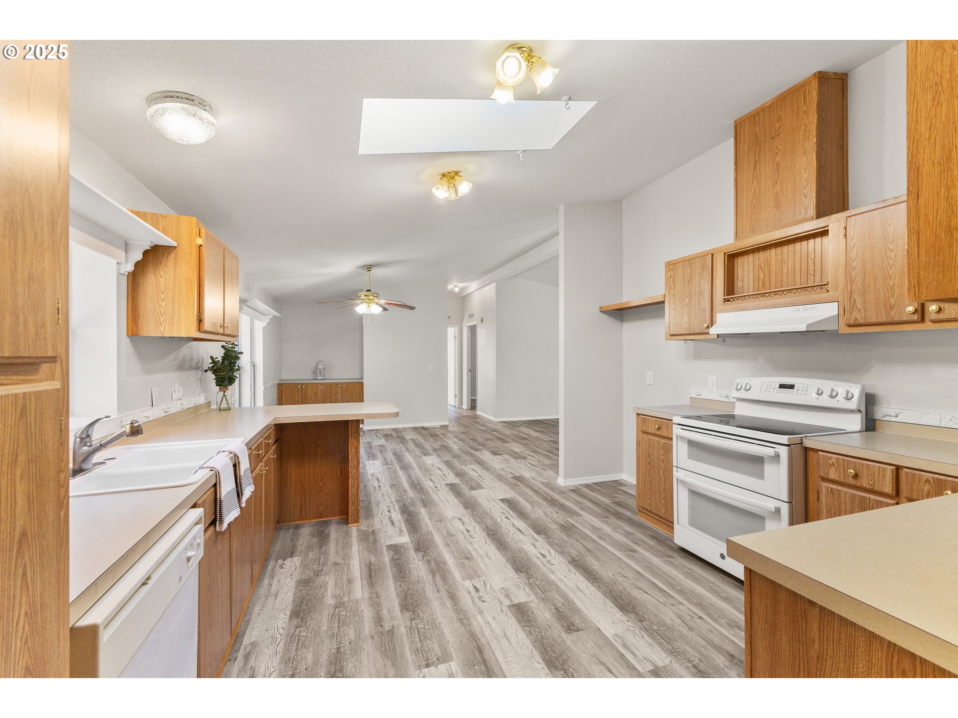 20191 Highway 42 Myrtle Point, OR 97458 - Photo 15 of 41 a kitchen with a sink cabinets stainless steel appliances and a counter top space