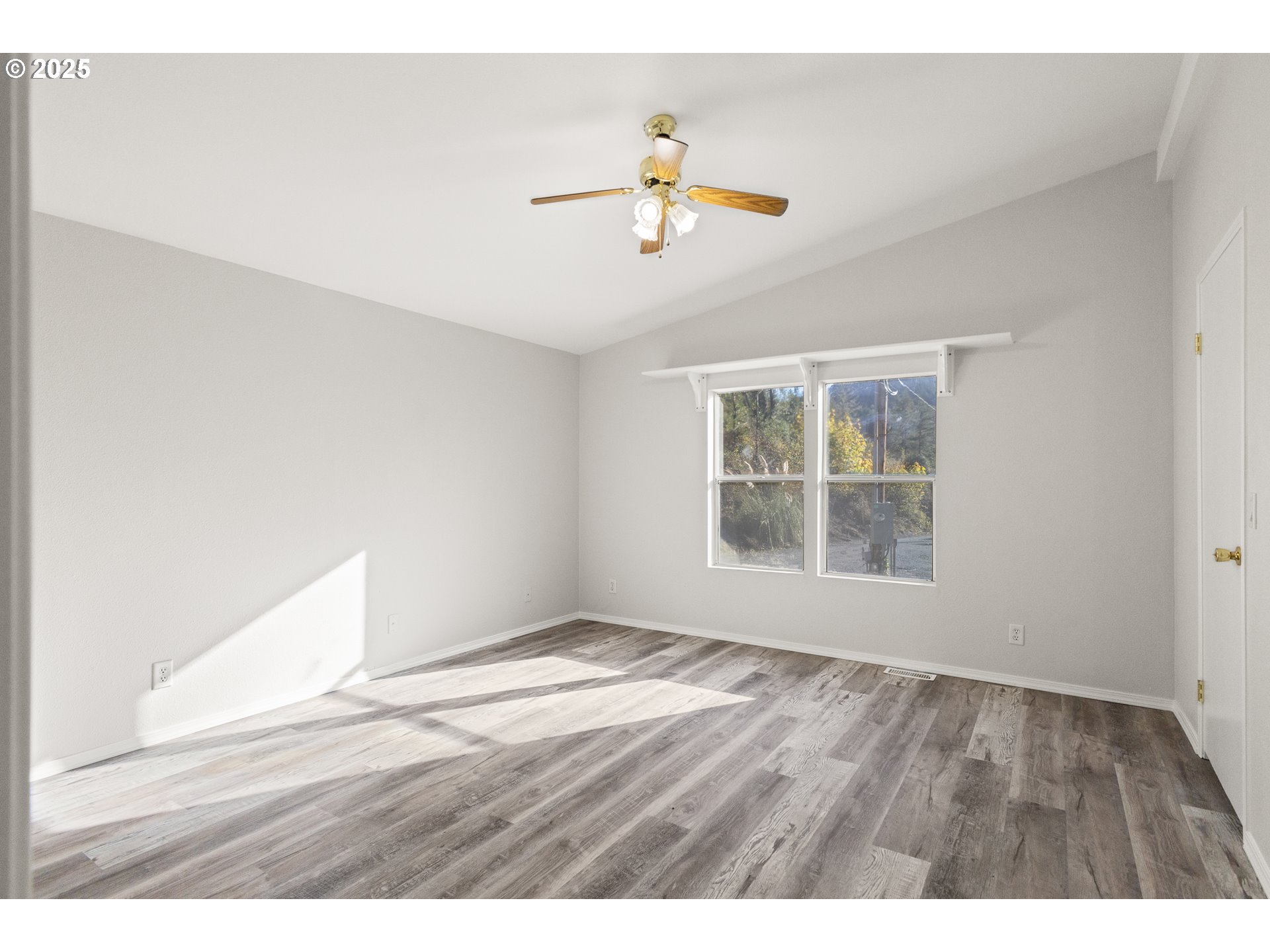 20191 Highway 42 Myrtle Point, OR 97458 - Photo 30 of 41 a view of an empty room with wooden floor and a window