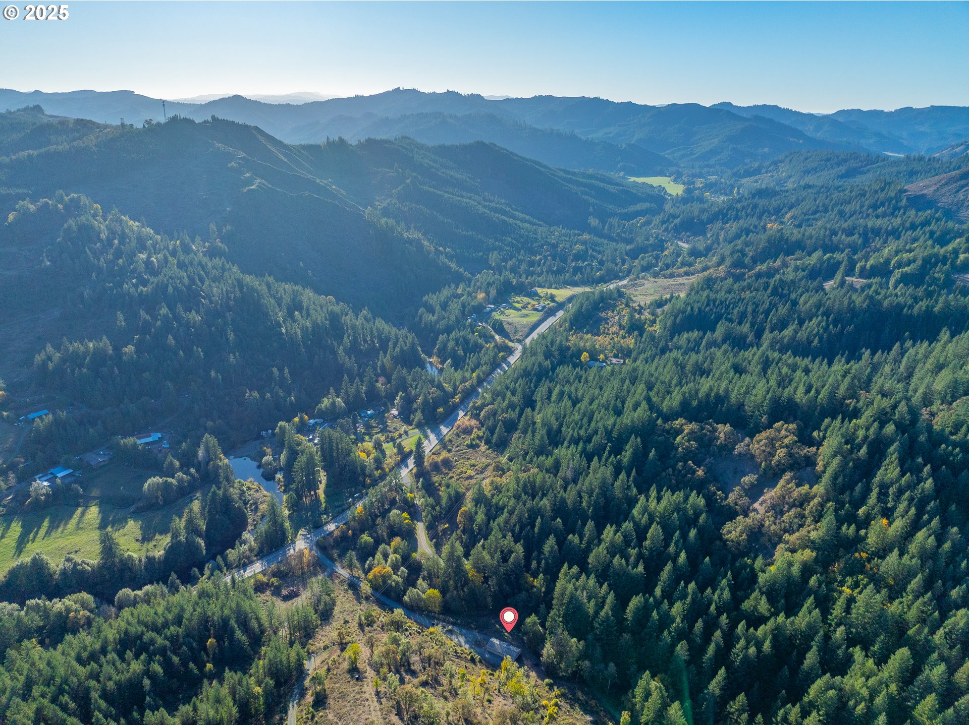 20191 Highway 42 Myrtle Point, OR 97458 - Photo 36 of 41 a view of a lush green field with mountains in the background