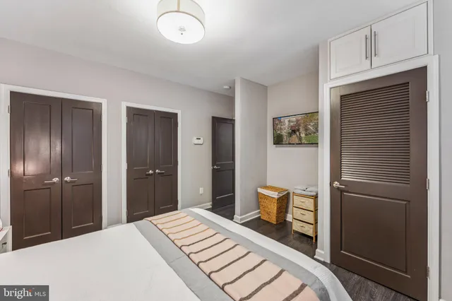 a bedroom with a bed and a refrigerator