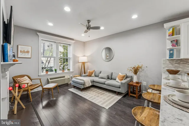 a living room with furniture and wooden floor