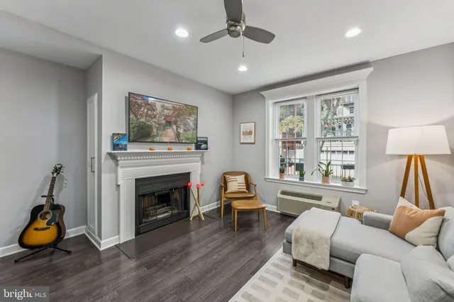 a living room with furniture and a fireplace