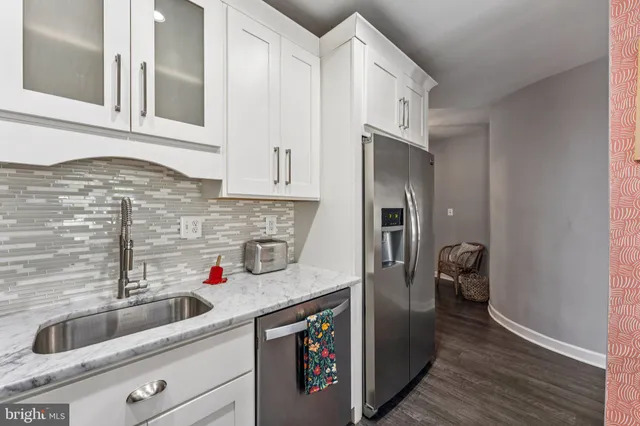 a kitchen with a sink and a refrigerator