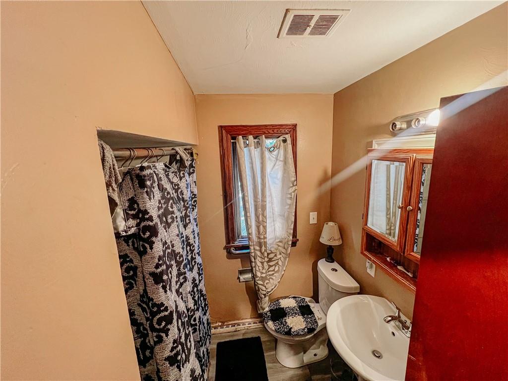 1638 Shady Drive Farrell, PA 16121 - Photo 10 of 21 a bathroom with a toilet sink and mirror