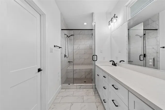 a spacious bathroom with a shower sink and mirror