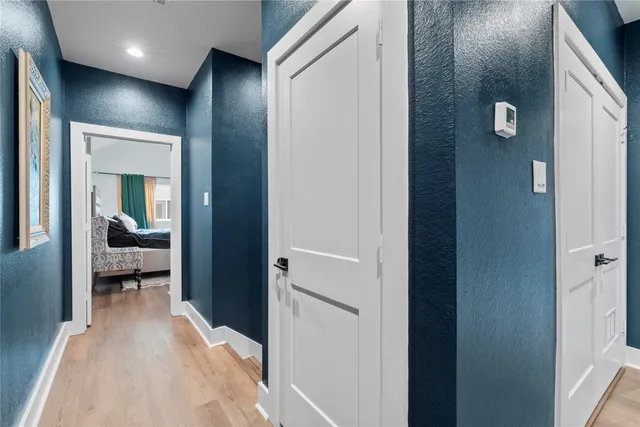 a view of a hallway with a livingroom and a bathroom