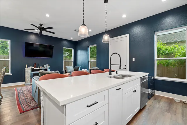 a living room with furniture a flat screen tv and a large window