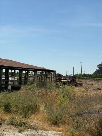 a view of a yard with wooden fence