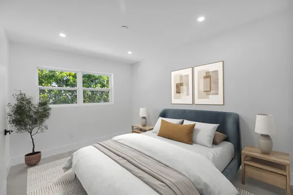 a bedroom with bed and a window