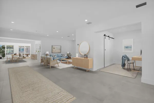 a view of a livingroom with furniture and a table chairs