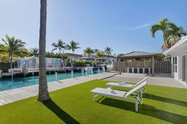 a swimming pool with outdoor seating and yard