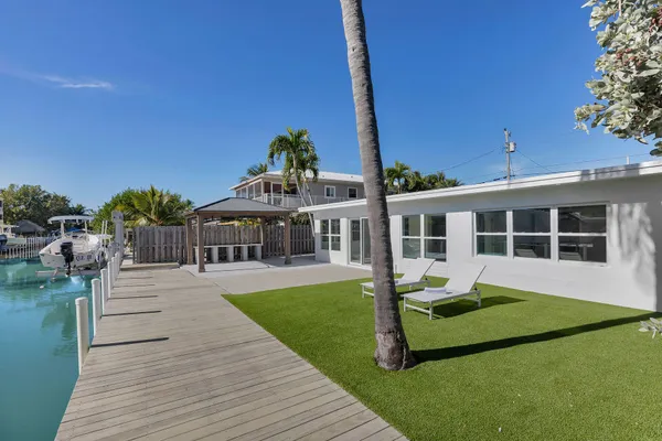 a front view of a house with a yard table and chairs