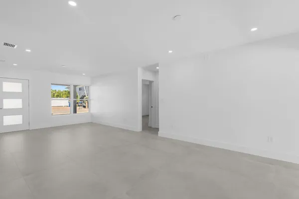 an empty room with windows and entrance