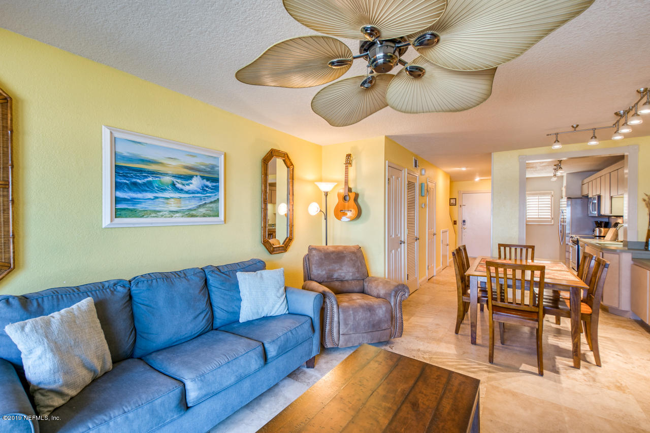 8550 A1A South, Unit 408 St. Augustine, FL 32080 - Photo 12 of 33 a living room with furniture ceiling fan and a rug
