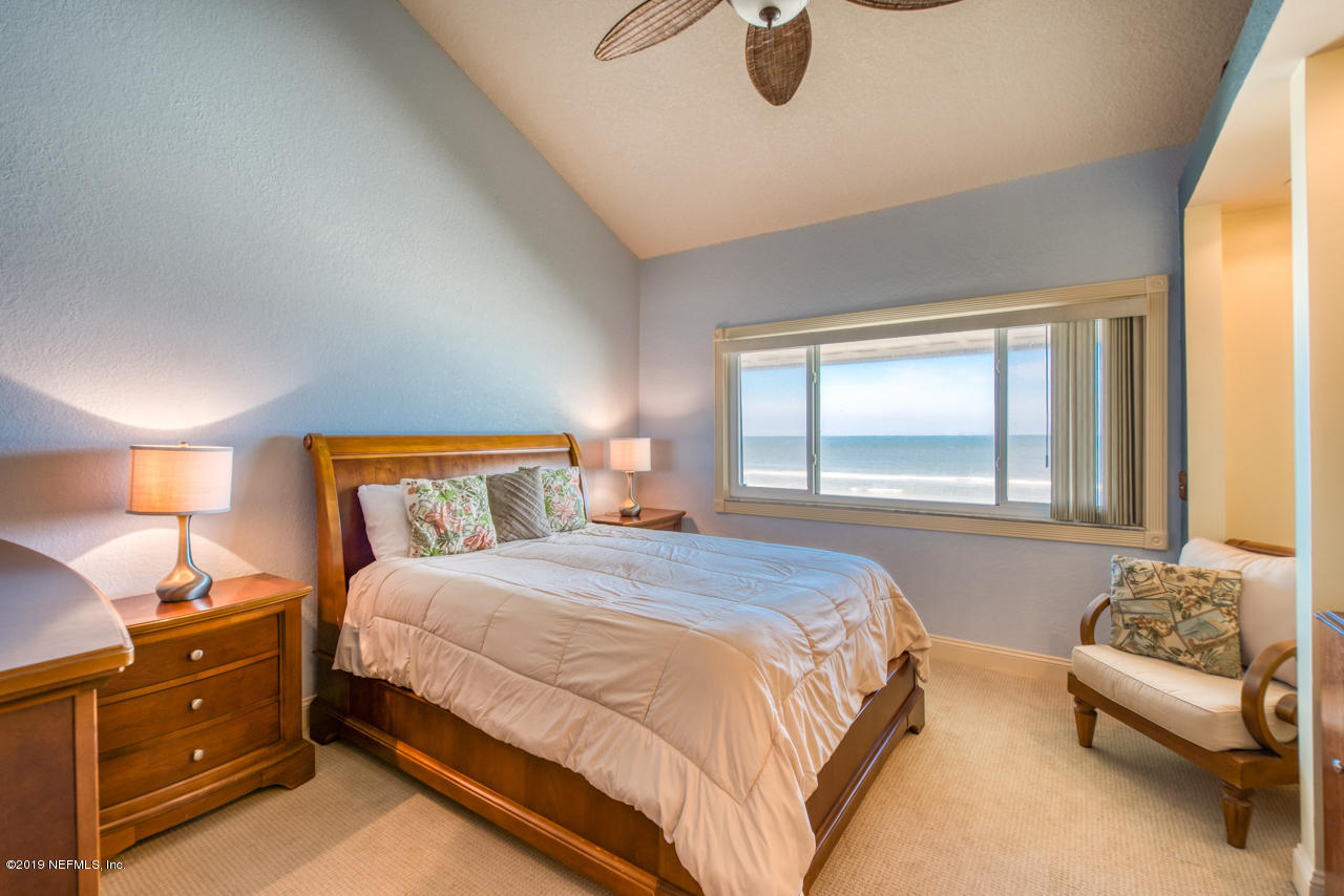 8550 A1A South, Unit 408 St. Augustine, FL 32080 - Photo 14 of 33 a bedroom with a bed and a couch