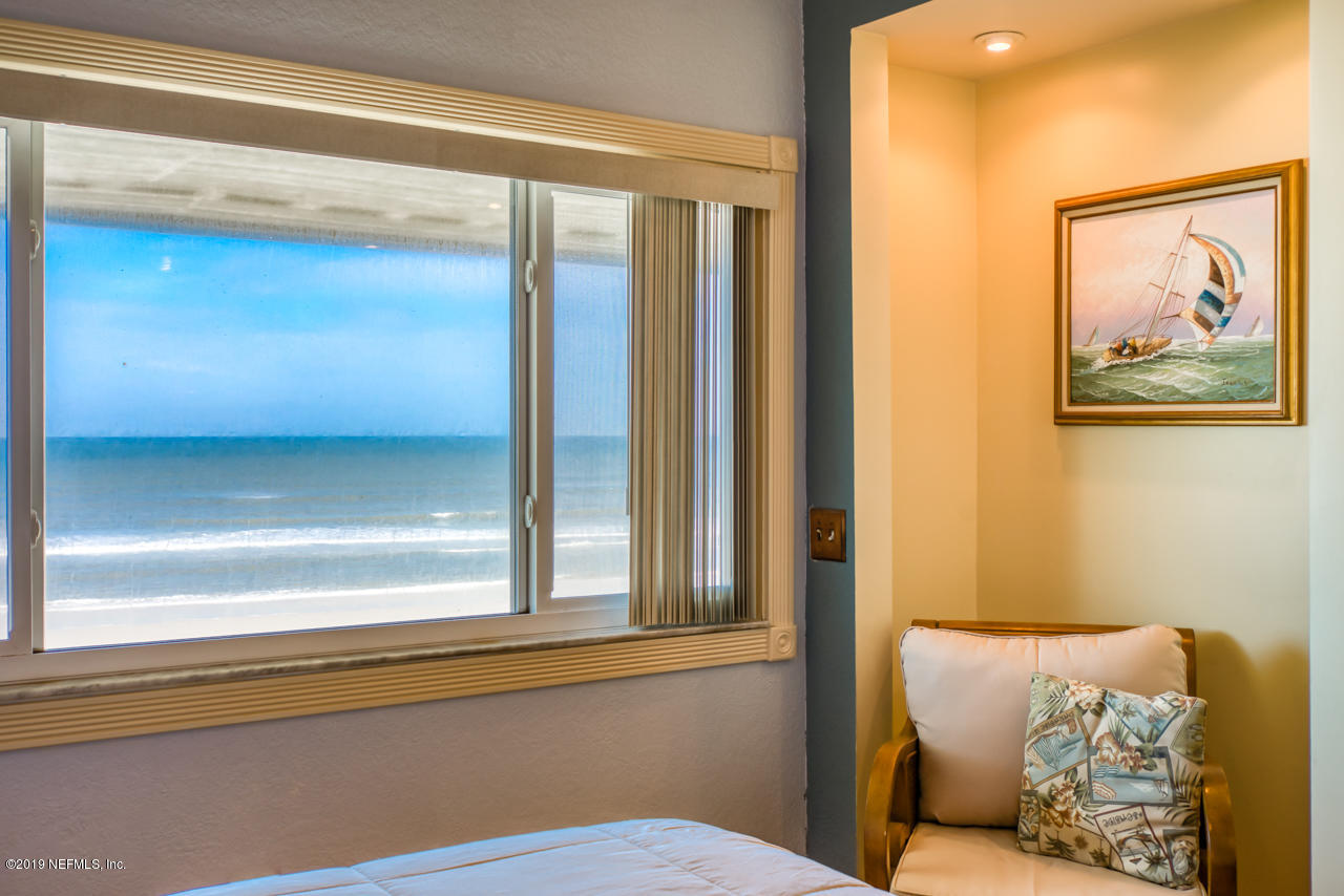 8550 A1A South, Unit 408 St. Augustine, FL 32080 - Photo 17 of 33 a view of a bedroom with furniture and windows