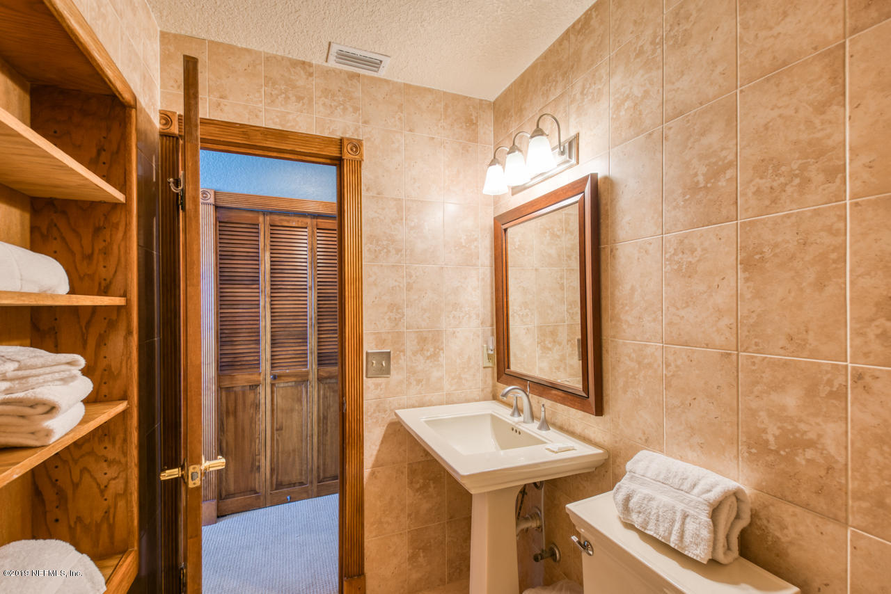 8550 A1A South, Unit 408 St. Augustine, FL 32080 - Photo 19 of 33 a bathroom with a sink a toilet and shower