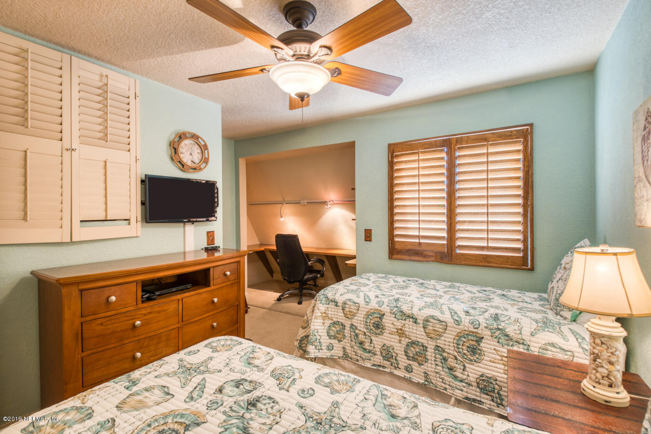 8550 A1A South, Unit 408 St. Augustine, FL 32080 - Photo 22 of 33 a bedroom with a bed and a flat screen tv
