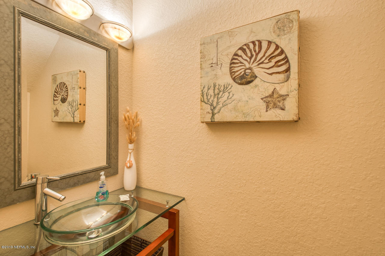 8550 A1A South, Unit 408 St. Augustine, FL 32080 - Photo 24 of 33 a bathroom with a sink and a mirror