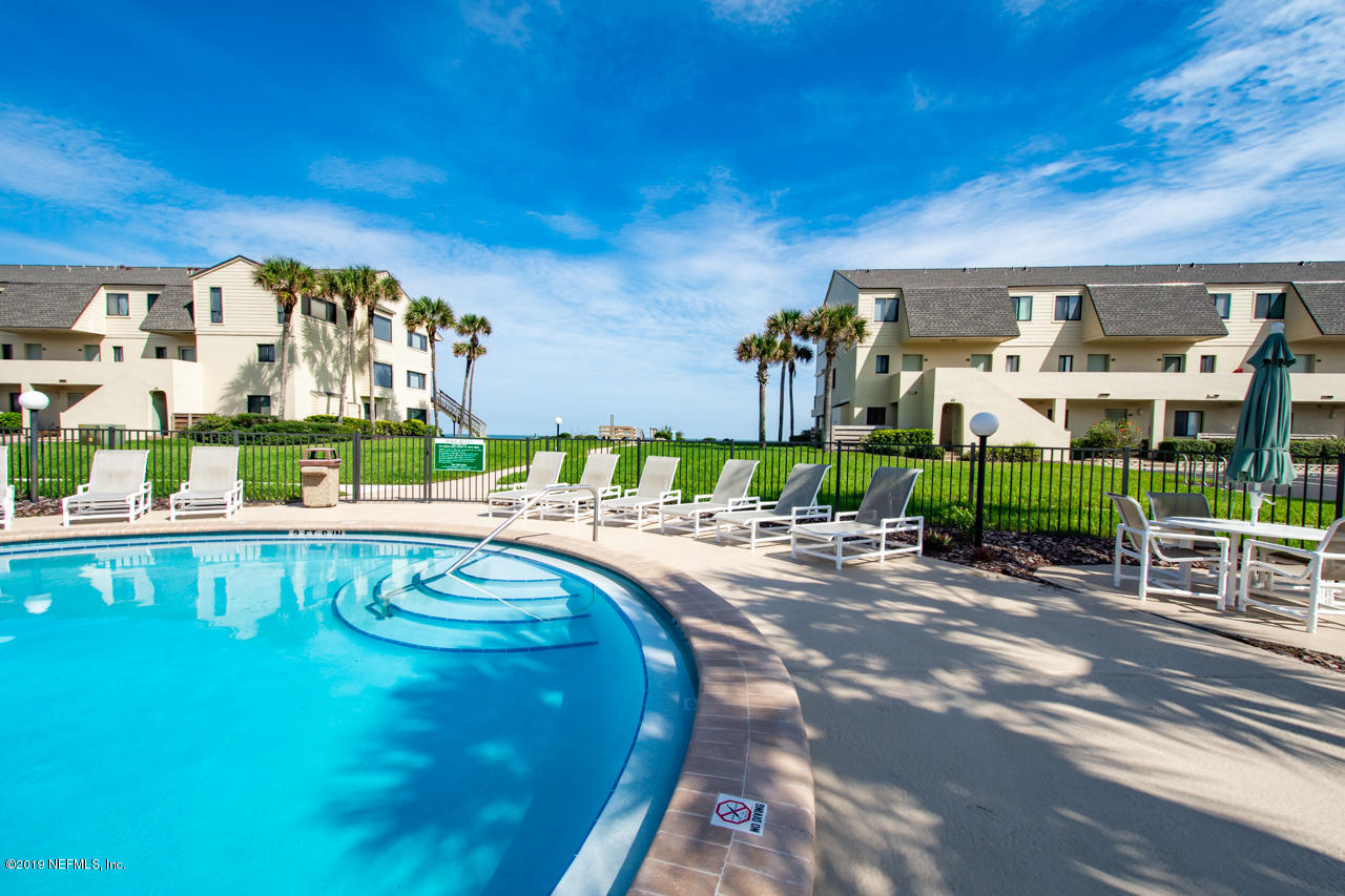 8550 A1A South, Unit 408 St. Augustine, FL 32080 - Photo 6 of 33 a swimming pool with outdoor seating and yard