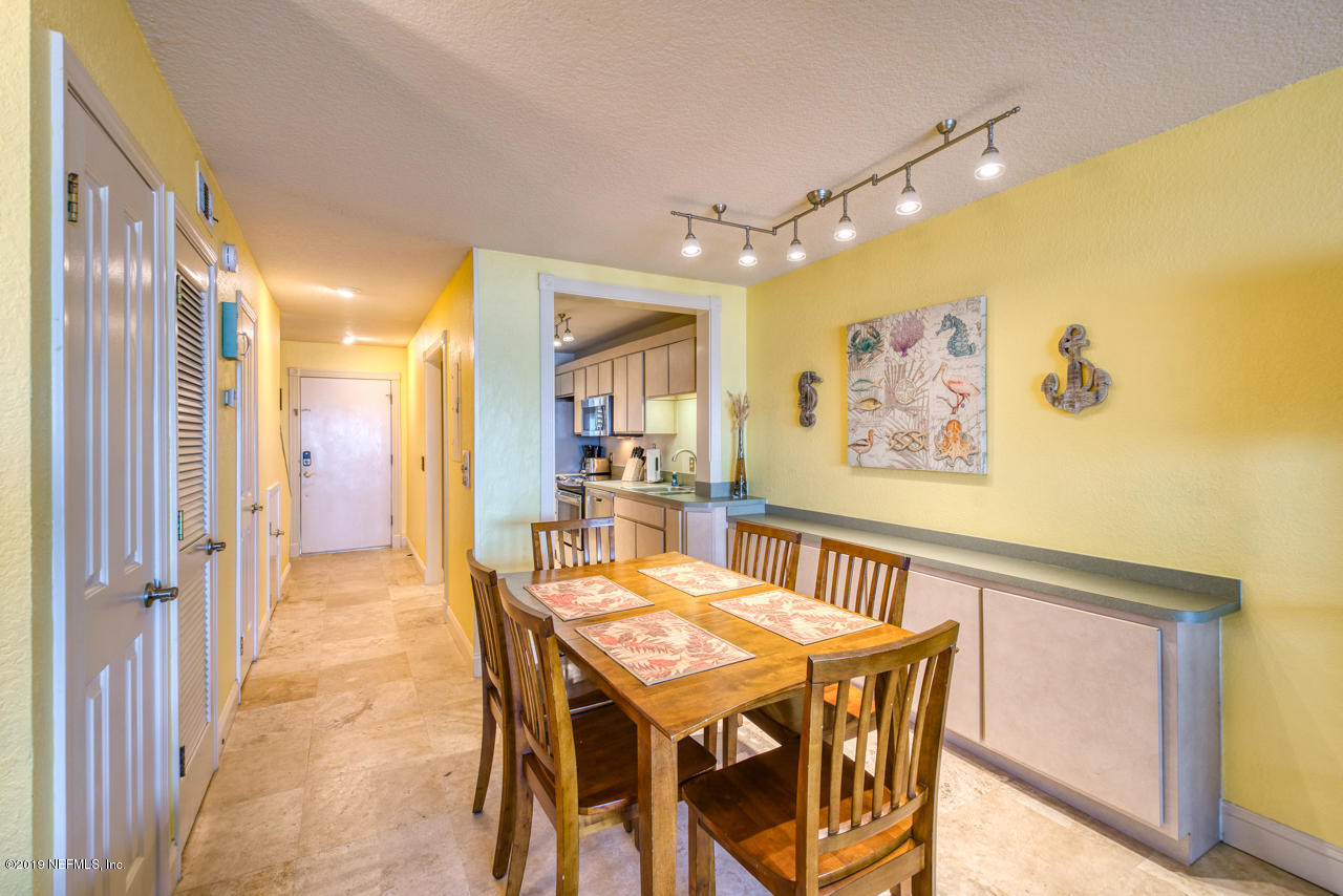 8550 A1A South, Unit 408 St. Augustine, FL 32080 - Photo 7 of 33 a view of a dining room with furniture and a chandelier