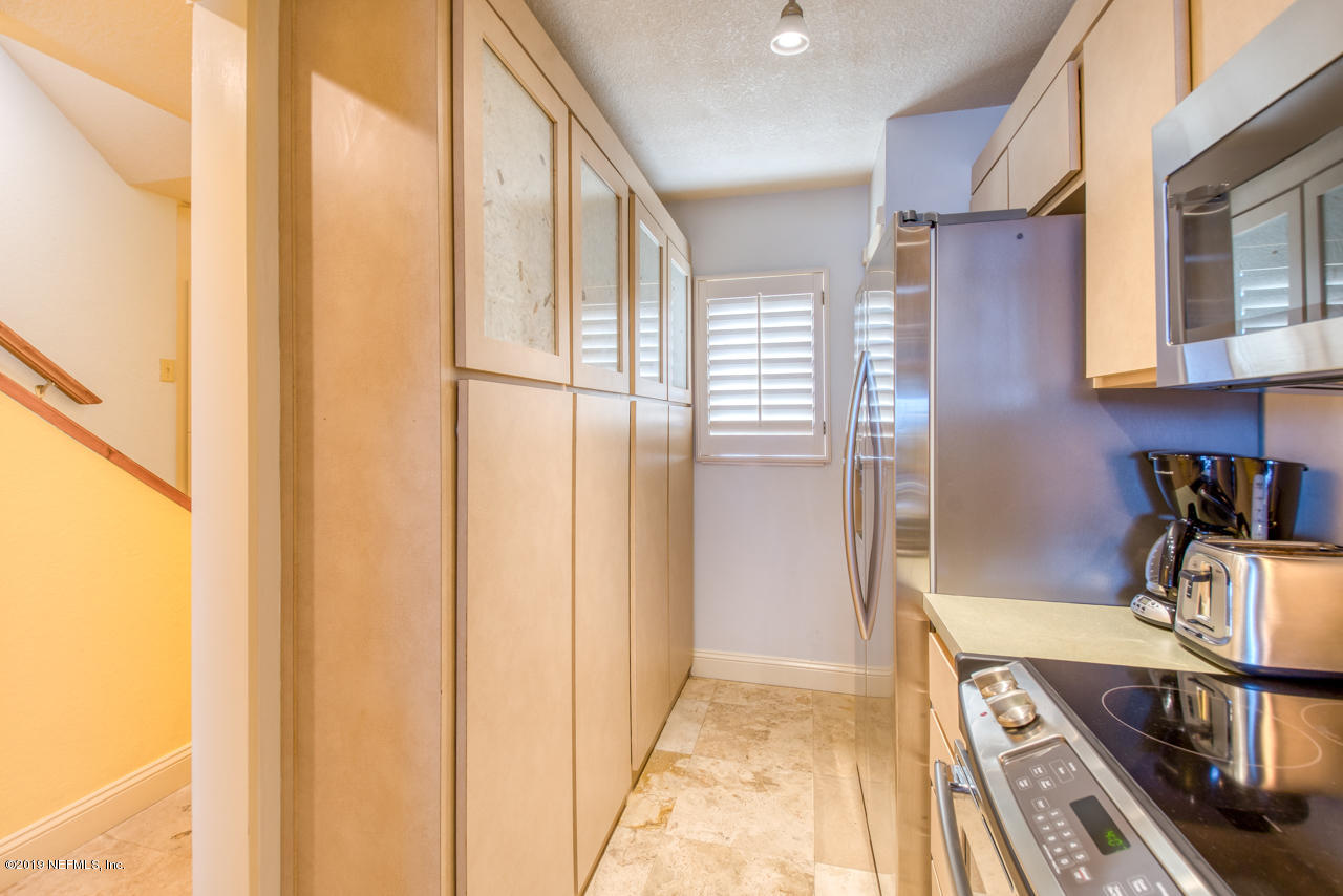 8550 A1A South, Unit 408 St. Augustine, FL 32080 - Photo 9 of 33 a view of a kitchen with a sink and cabinets