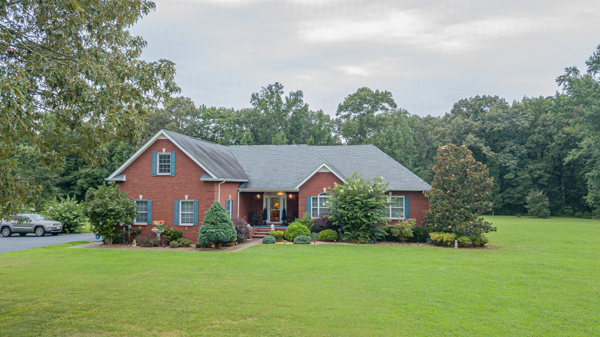 2828 Bains Road Hillsboro, TN 37342 - Photo 1 of 50 a front view of a house with a yard and trees