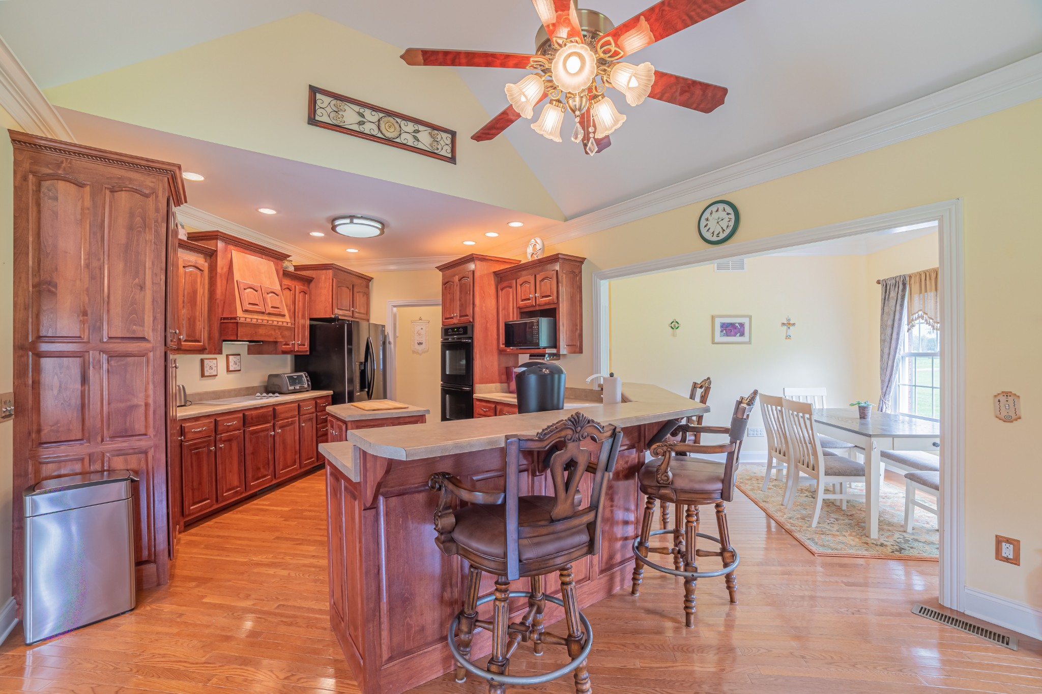 2828 Bains Road Hillsboro, TN 37342 - Photo 25 of 50 a kitchen with stainless steel appliances kitchen island granite countertop a table chairs and a refrigerator