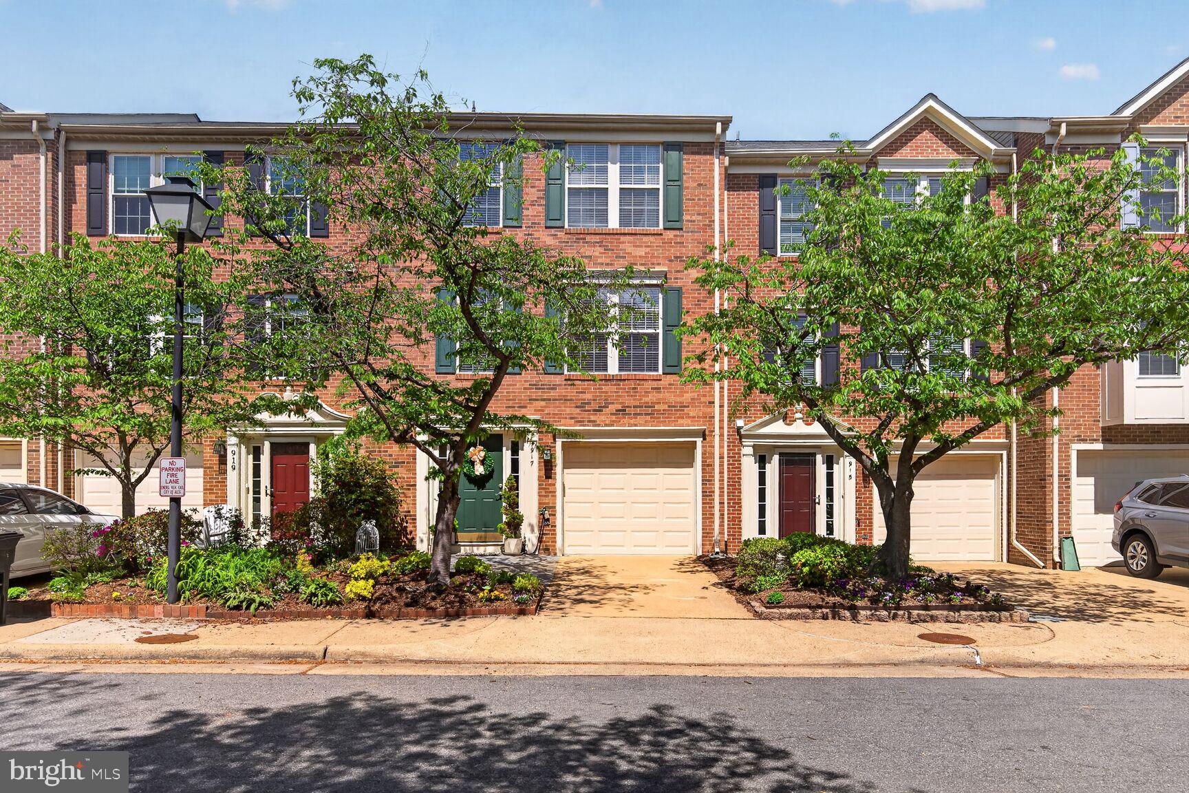 a front view of a house with a yard and potted plants