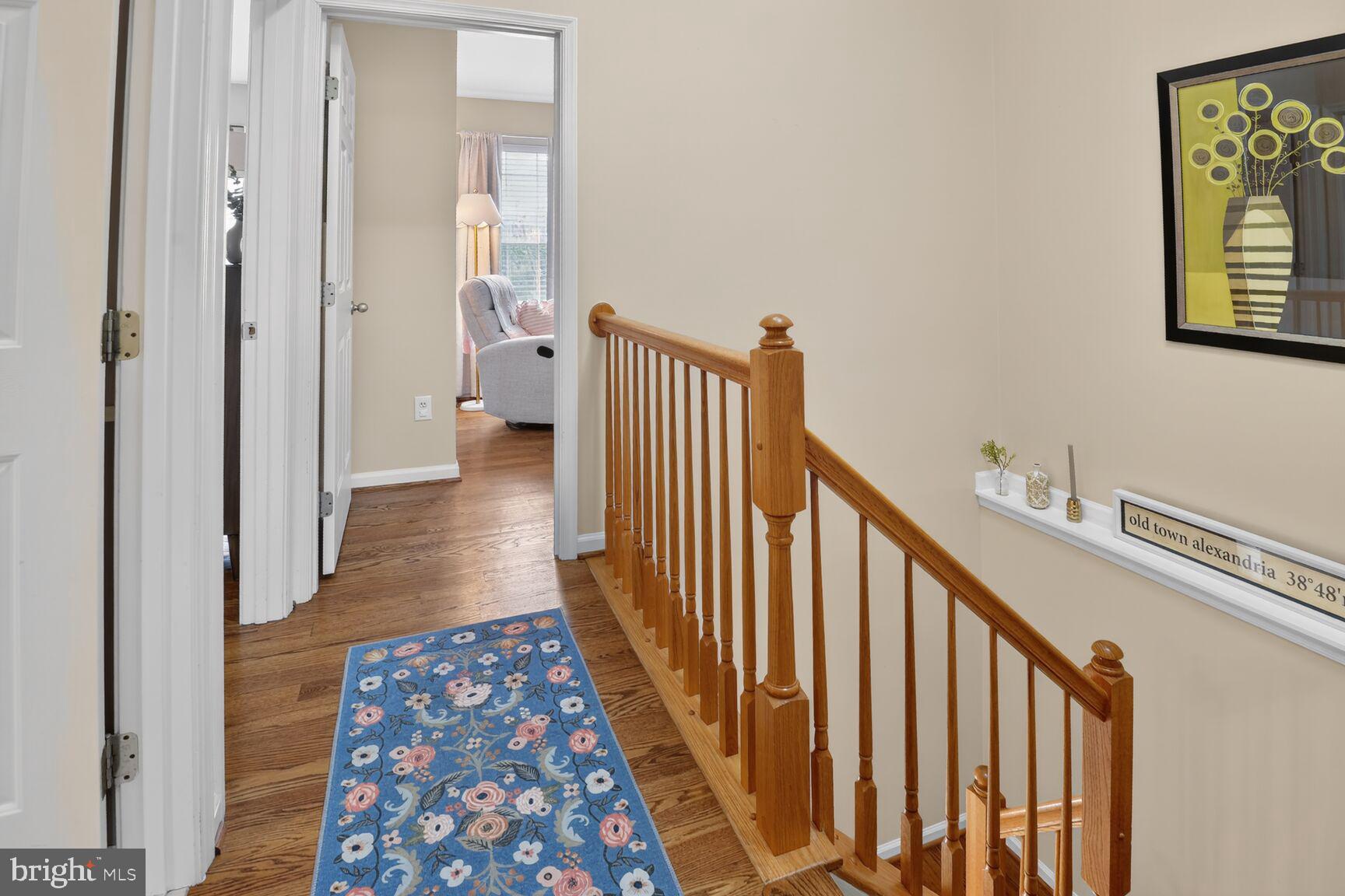 917 Rolfe Place Alexandria, VA 22314 - Photo 19 of 34 a view of a hallway with wooden floor and staircase